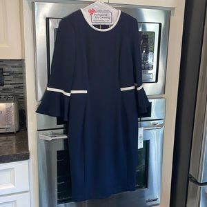 Calvin Klein never been worn classic, stunning black dress with white piping.